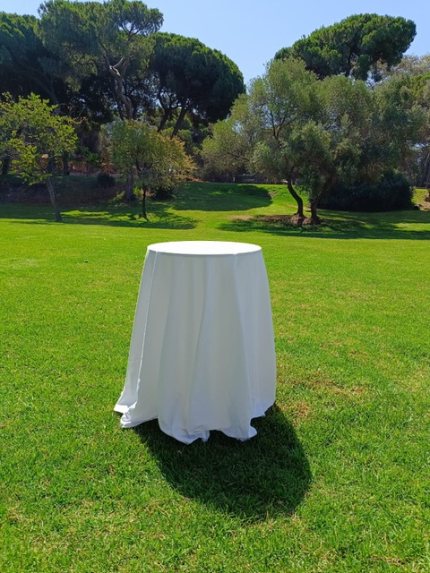 Mesa alta vestida con mantel de satén blanco